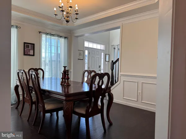 a view of a a dining room with furniture and window