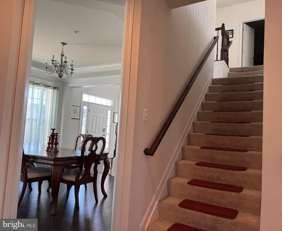 a view of entryway and hall with dining room
