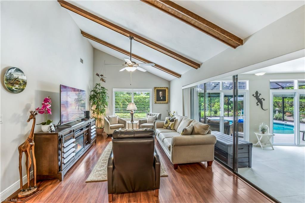 2232 Buckingham Lane Naples, FL 34112 - Photo 11 of 30 a living room with furniture and a large window