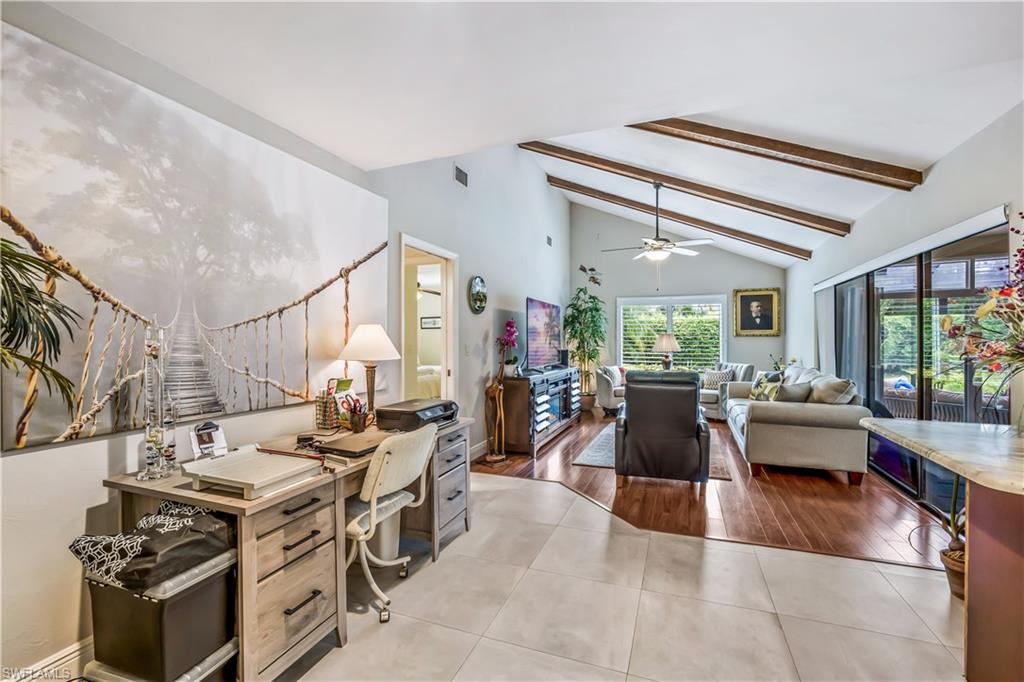 2232 Buckingham Lane Naples, FL 34112 - Photo 12 of 30 a living room with furniture and a large window