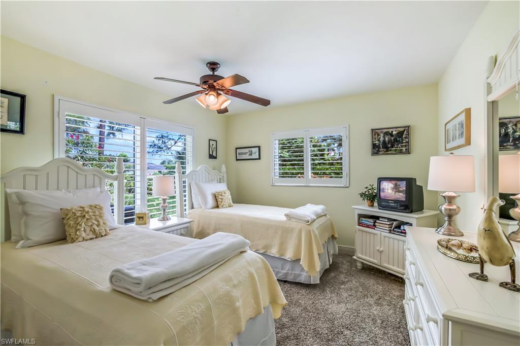 2232 Buckingham Lane Naples, FL 34112 - Photo 15 of 30 a bedroom with a large bed and a tv