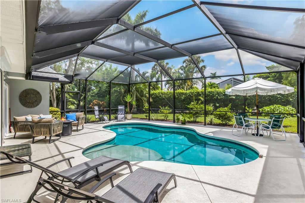 2232 Buckingham Lane Naples, FL 34112 - Photo 20 of 30 an outdoor space with furniture and umbrella