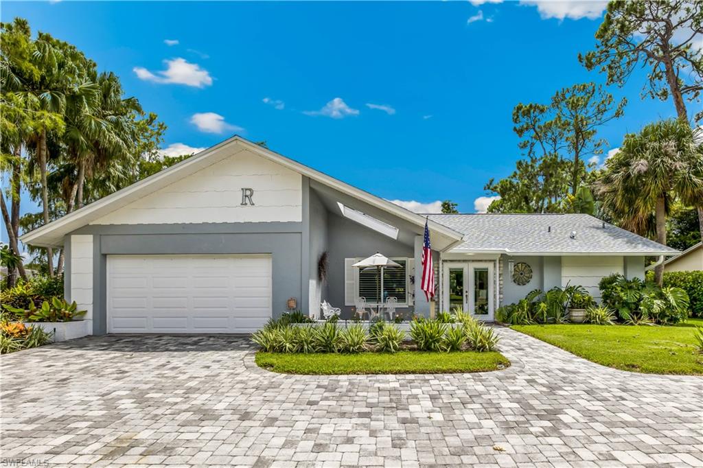 2232 Buckingham Lane Naples, FL 34112 - Photo 2 of 30 a front view of a house with a yard and potted plants