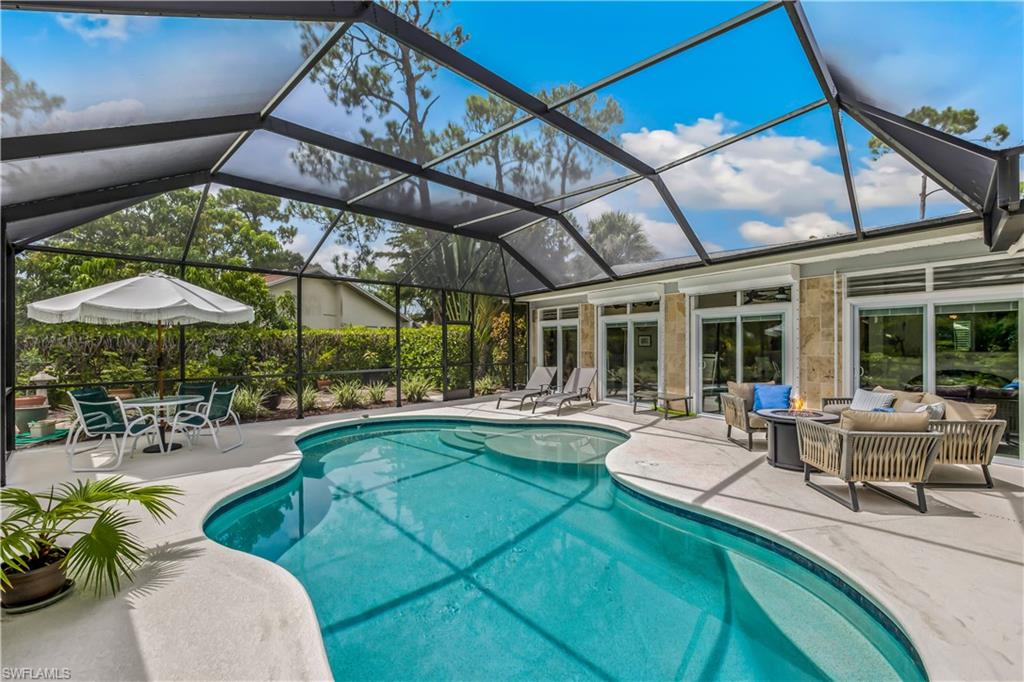 2232 Buckingham Lane Naples, FL 34112 - Photo 21 of 30 a view of a swimming pool with a patio