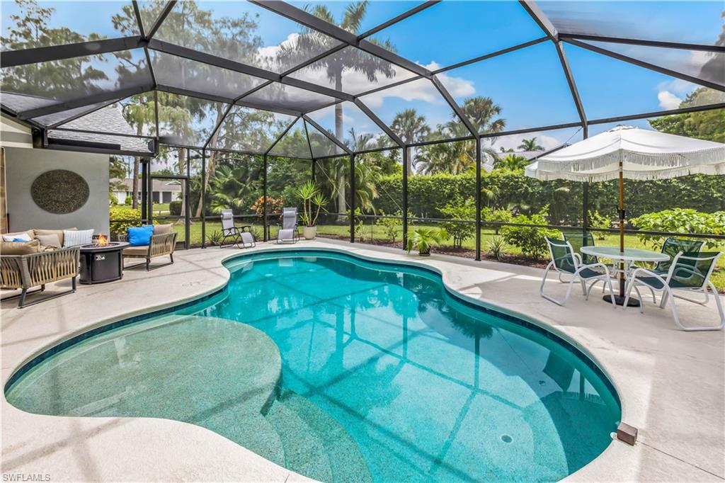 2232 Buckingham Lane Naples, FL 34112 - Photo 22 of 30 a view of a swimming pool with a patio