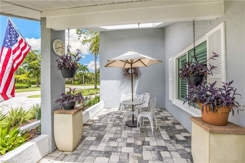 2232 Buckingham Lane Naples, FL 34112 - Photo 25 of 30 a living room filled with furniture and a potted plant