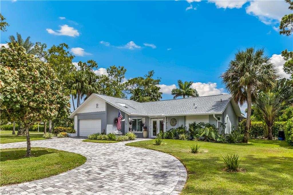 2232 Buckingham Lane Naples, FL 34112 - Photo 30 of 30 a front view of a house with a garden and yard