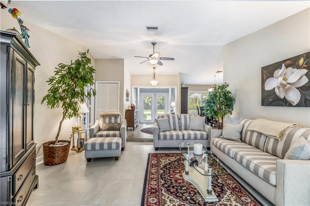 2232 Buckingham Lane Naples, FL 34112 - Photo 3 of 30 a living room with furniture and a chandelier