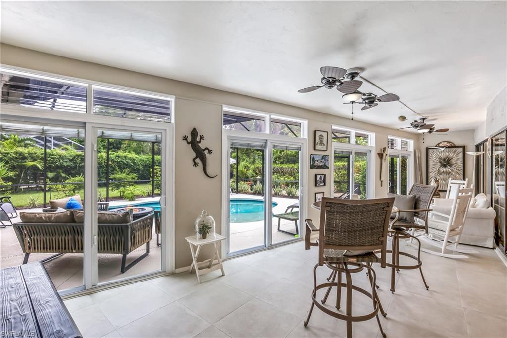 2232 Buckingham Lane Naples, FL 34112 - Photo 7 of 30 a view of a dining room with furniture large windows and wooden floor