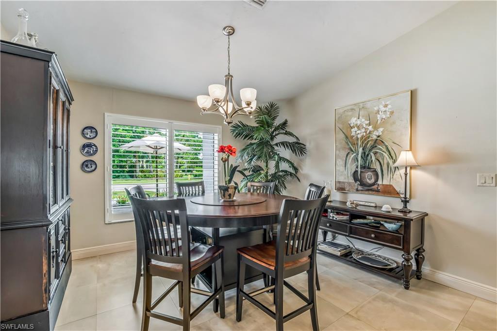 2232 Buckingham Lane Naples, FL 34112 - Photo 9 of 30 a dining room with furniture a chandelier and window