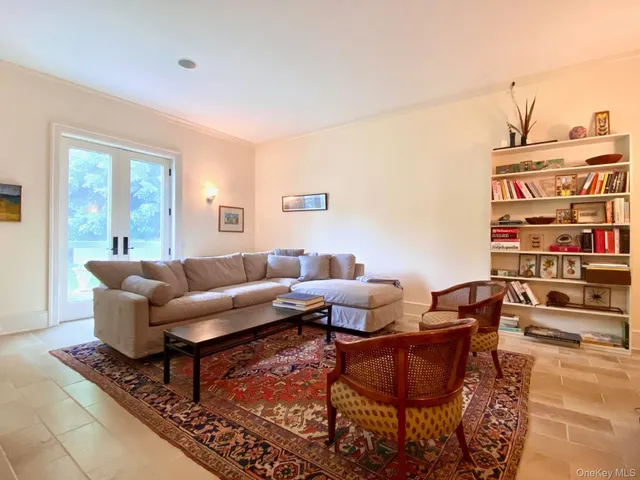 a living room with furniture a rug and a window