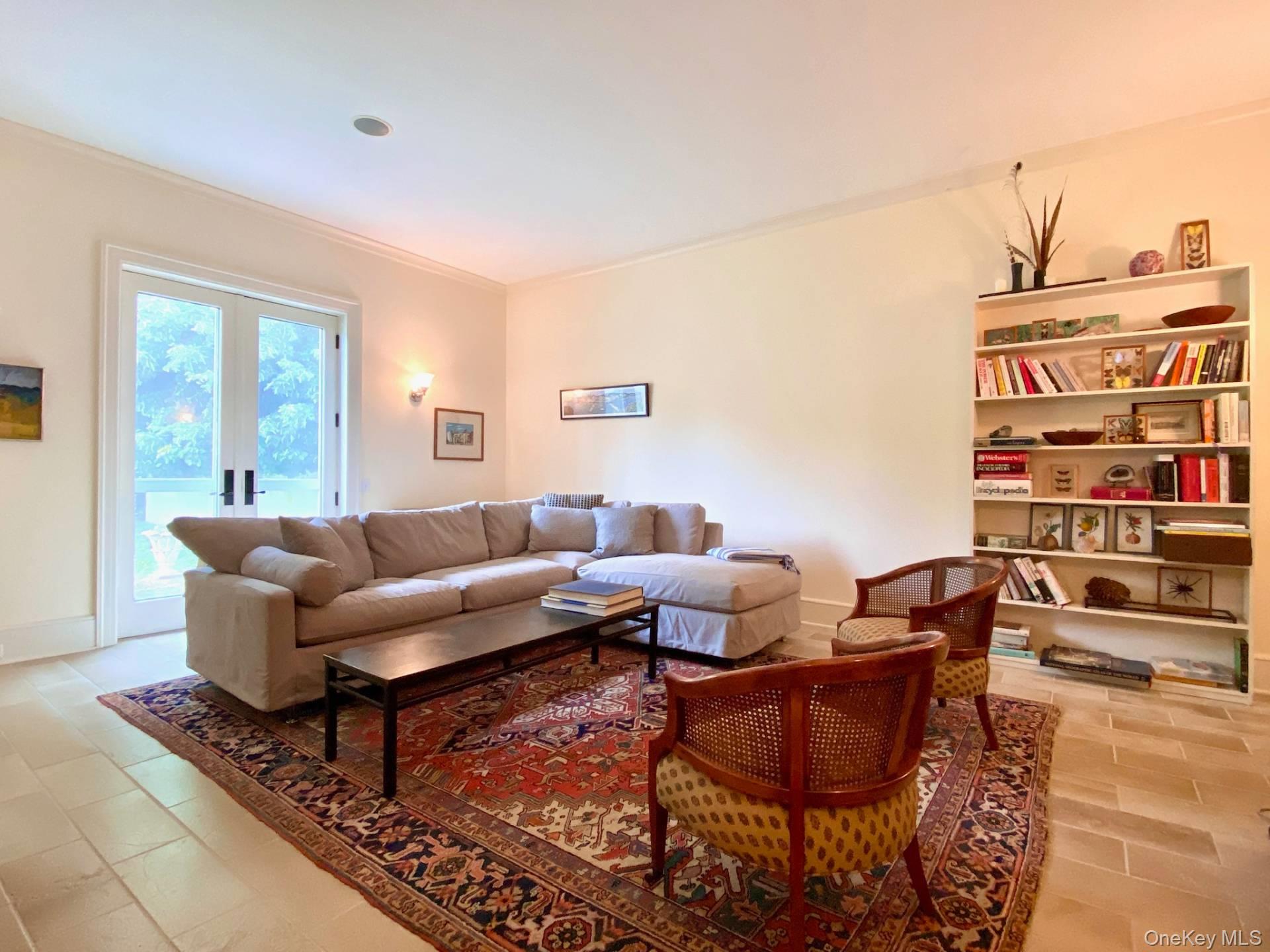 2840 Stars Road East Marion, NY 11939 - Photo 12 of 18 Living room featuring baseboards, ornamental molding, and french doors