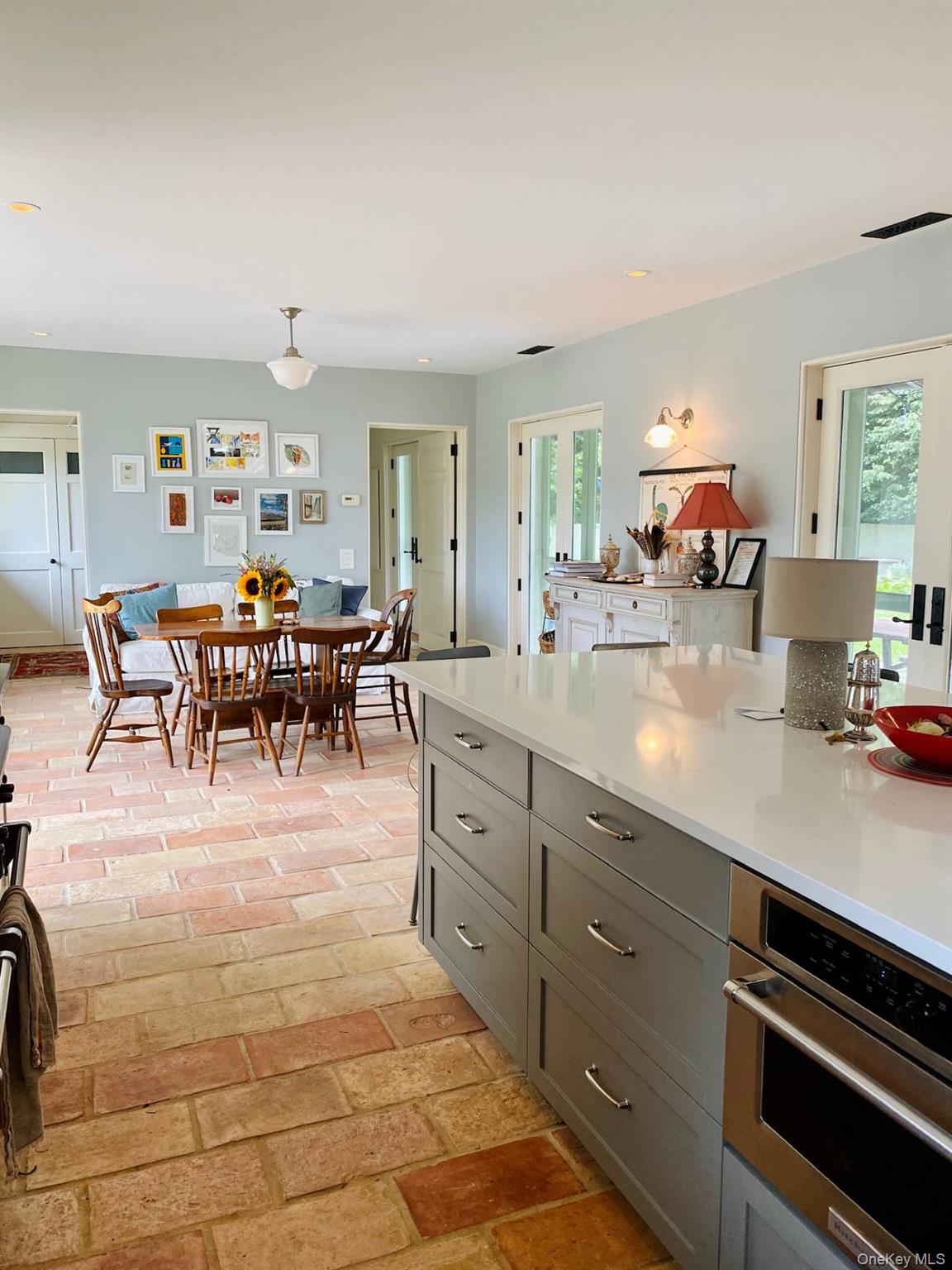 2840 Stars Road East Marion, NY 11939 - Photo 6 of 18 Kitchen featuring light countertops, gray cabinets, a healthy amount of sunlight, and stainless steel oven