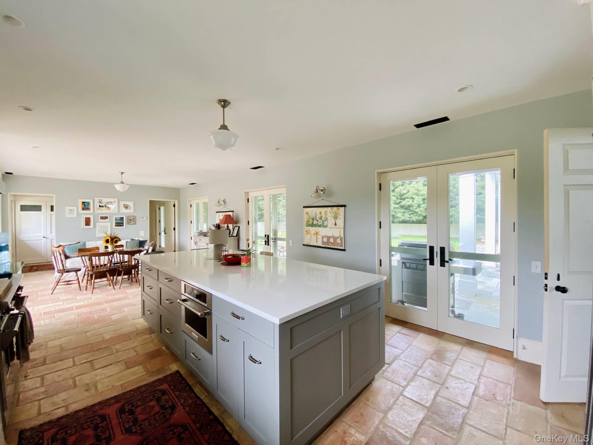 2840 Stars Road East Marion, NY 11939 - Photo 7 of 18 Kitchen with gray cabinets, a wealth of natural light, french doors, and oven