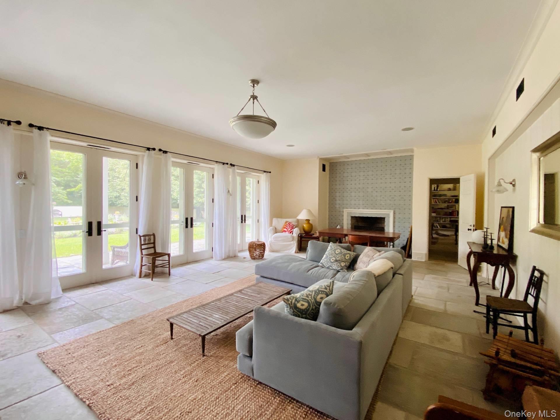 2840 Stars Road East Marion, NY 11939 - Photo 10 of 18 Living area with a fireplace and french doors