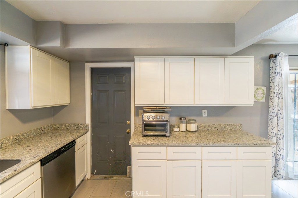 16403 Seneca Road Victorville, CA 92395 - Photo 12 of 47 a kitchen with stainless steel appliances granite countertop a sink and cabinets