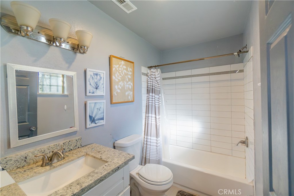 16403 Seneca Road Victorville, CA 92395 - Photo 20 of 47 a bathroom with a granite countertop sink toilet and shower