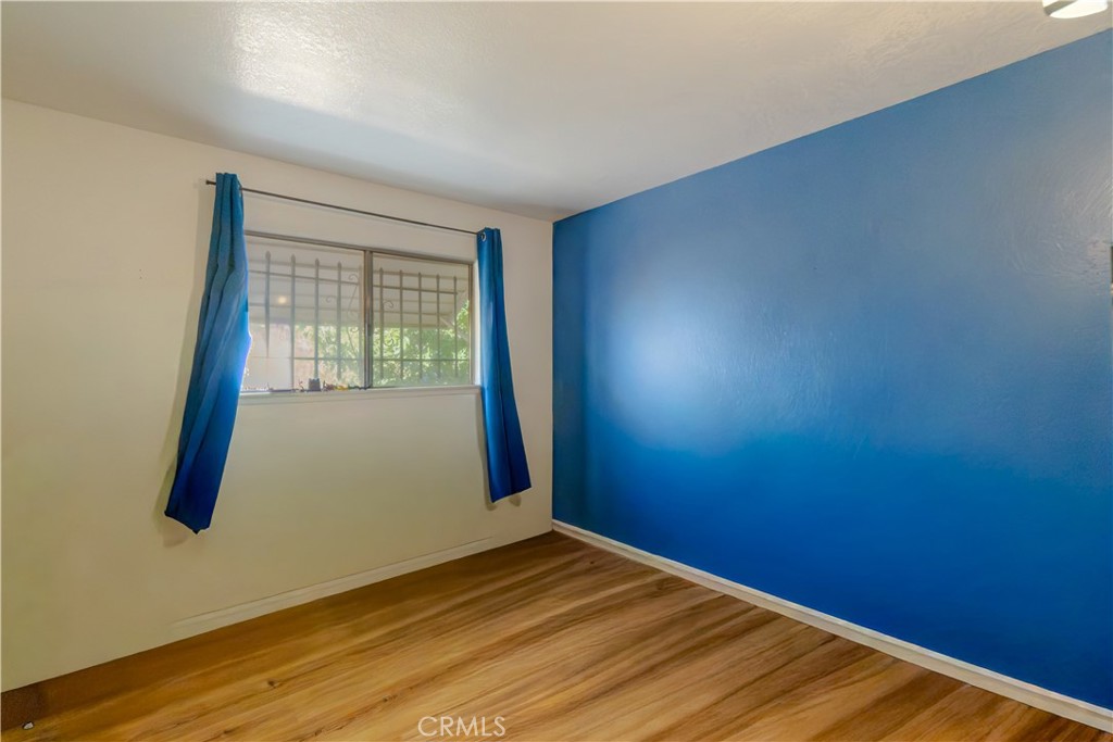 16403 Seneca Road Victorville, CA 92395 - Photo 22 of 47 a view of empty room with wooden floor and fan