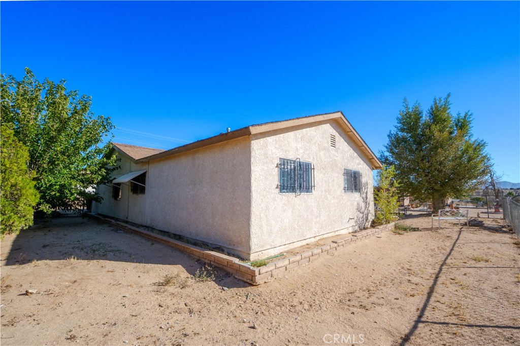 16403 Seneca Road Victorville, CA 92395 - Photo 27 of 47 a view of a house with a backyard