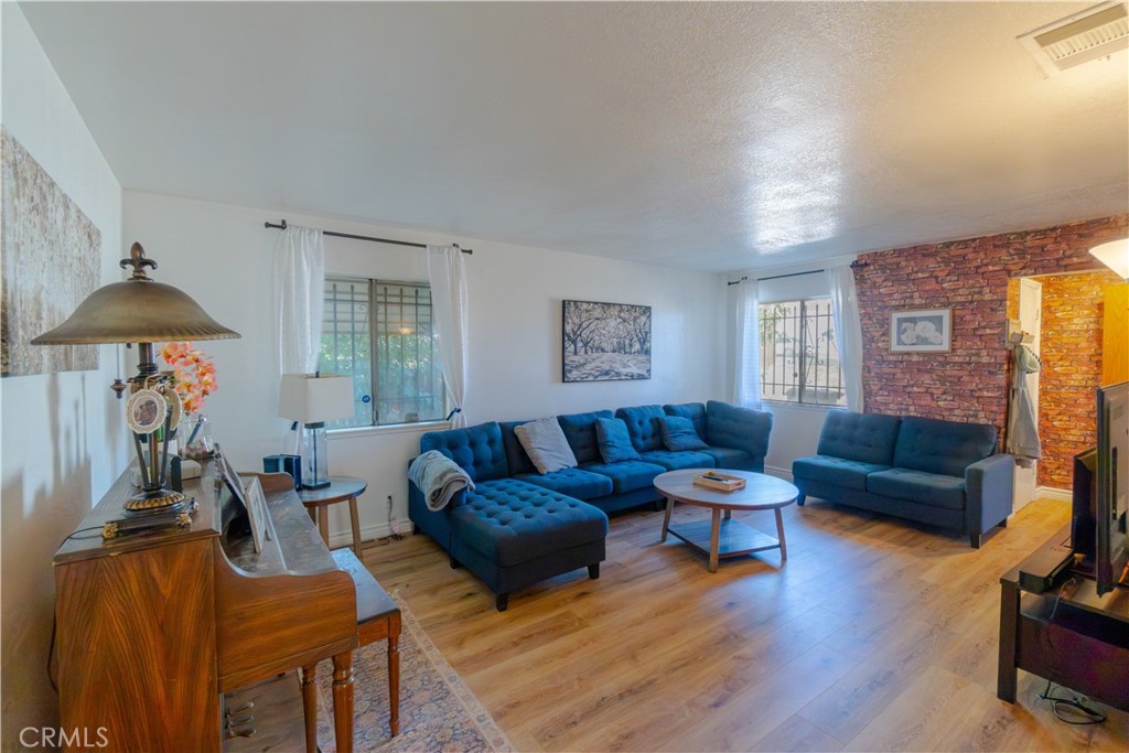 16403 Seneca Road Victorville, CA 92395 - Photo 5 of 47 a living room with furniture and a wooden floor