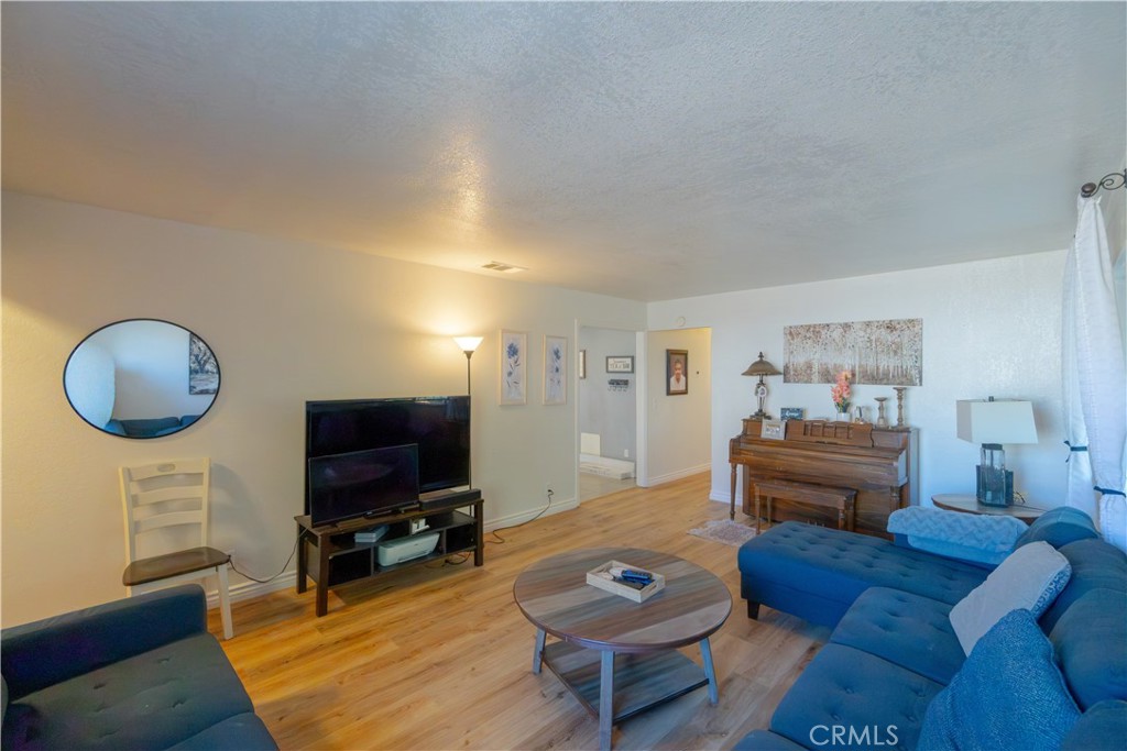 16403 Seneca Road Victorville, CA 92395 - Photo 7 of 47 a living room with furniture and a flat screen tv