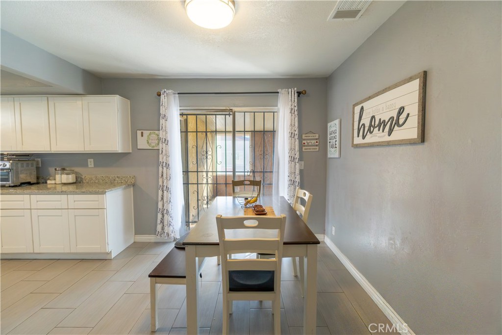 16403 Seneca Road Victorville, CA 92395 - Photo 8 of 47 a kitchen with stainless steel appliances granite countertop a stove a sink and a refrigerator