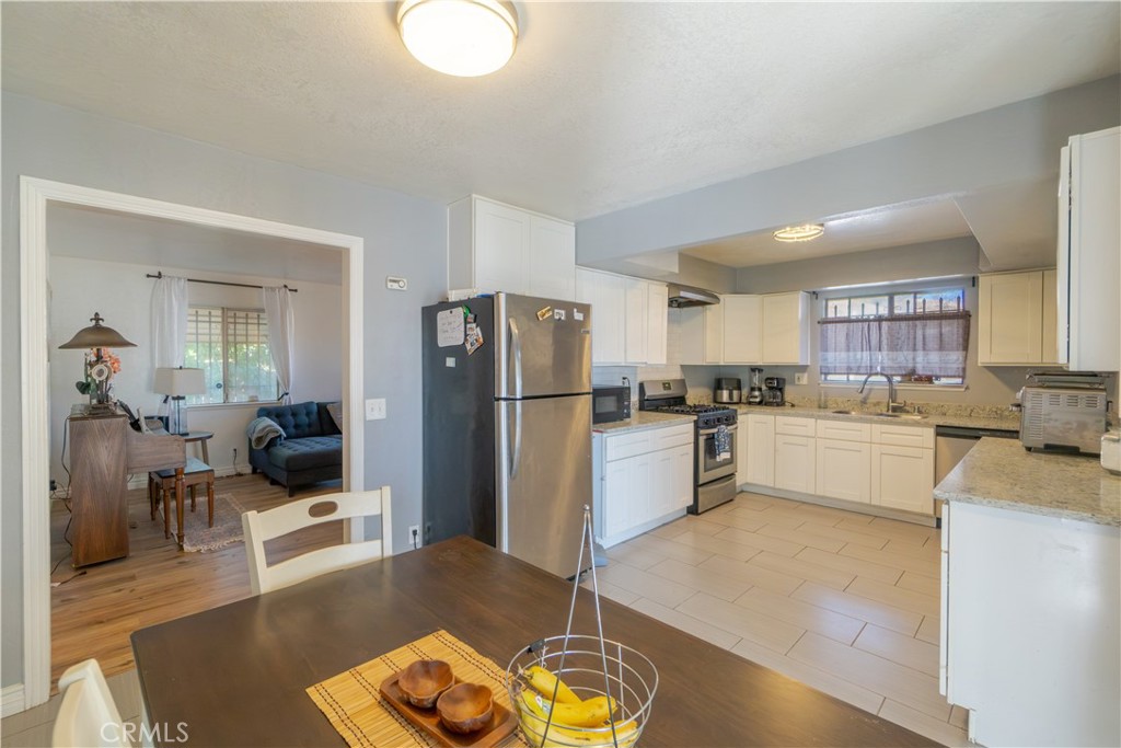 16403 Seneca Road Victorville, CA 92395 - Photo 9 of 47 a kitchen with a refrigerator and a stove top oven