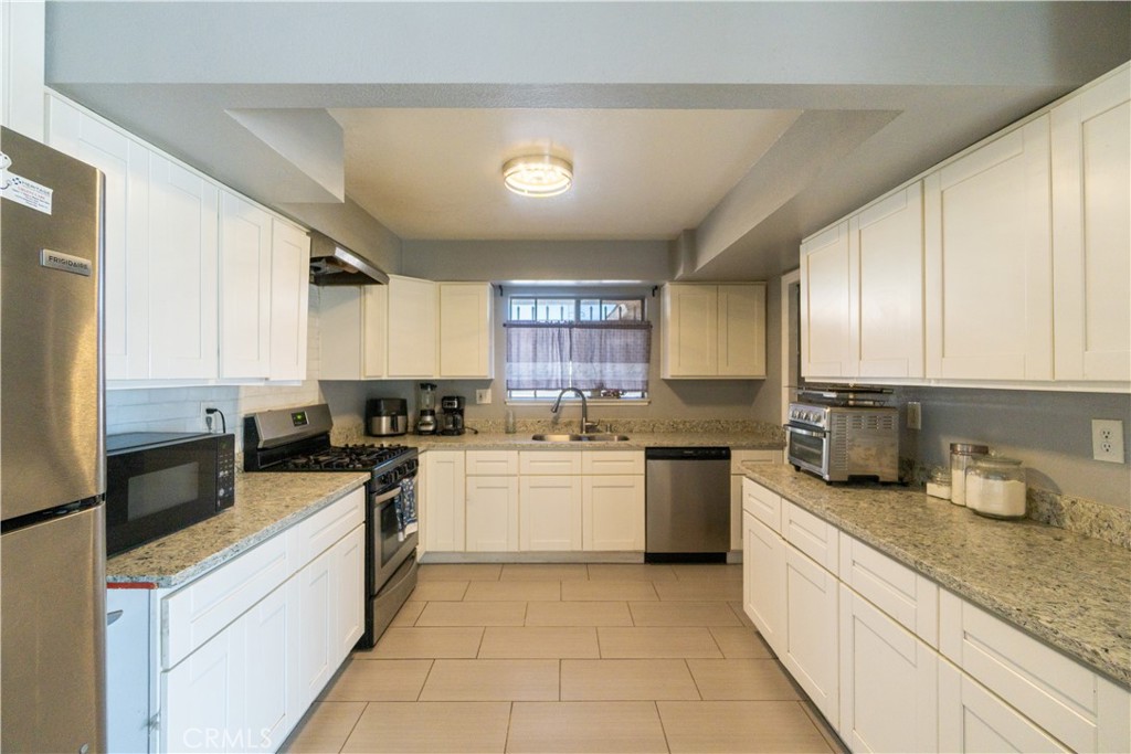 16403 Seneca Road Victorville, CA 92395 - Photo 10 of 47 a kitchen with a sink stove top oven and refrigerator