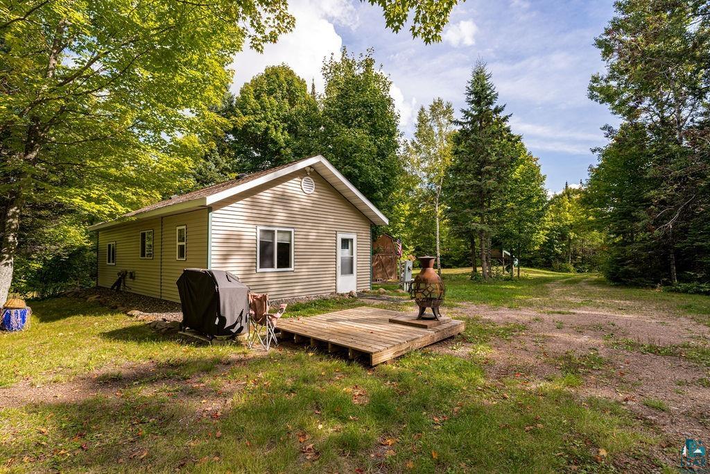 1159 Wales Road Two Harbors, MN 55616 - Photo 17 of 29 Single-story residence with horizontal siding, a gabled roof, and a wood deck