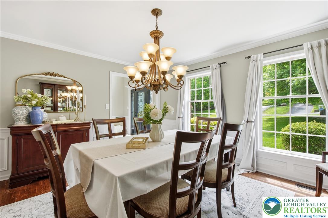 115 West Butternut Road Hellertown, PA 18055 - Photo 15 of 97 Well-lit dining room with polished hardwood floors and broad windows, perfect for memorable gatherings.