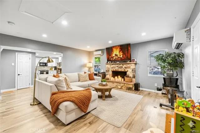 a living room with furniture a fireplace and a flat screen tv
