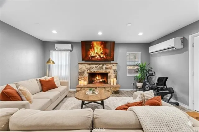 a living room with furniture and a fireplace