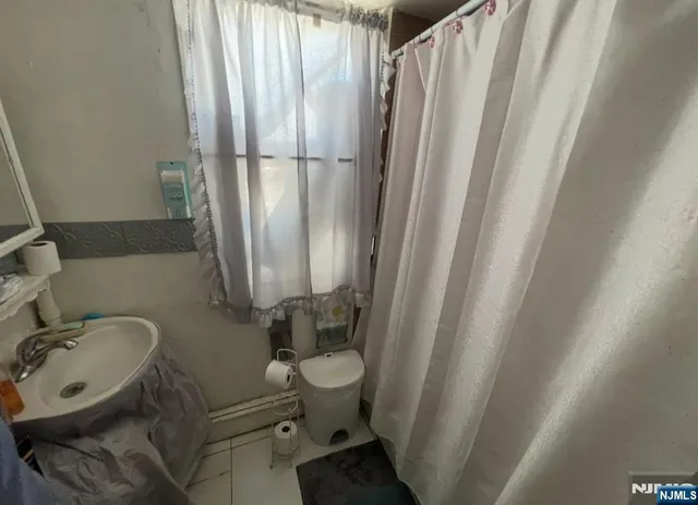 a bathroom with sink toilet and shower