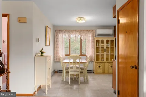 a dining room with furniture and window