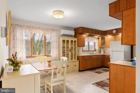 a living room with kitchen island granite countertop furniture a sink and a large window