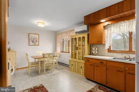 a large white kitchen with a large window
