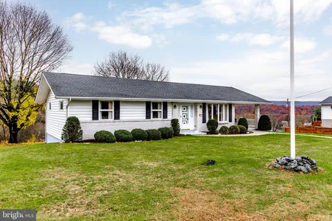 a view of a house with a backyard