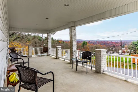 a view of a chairs and table in patio