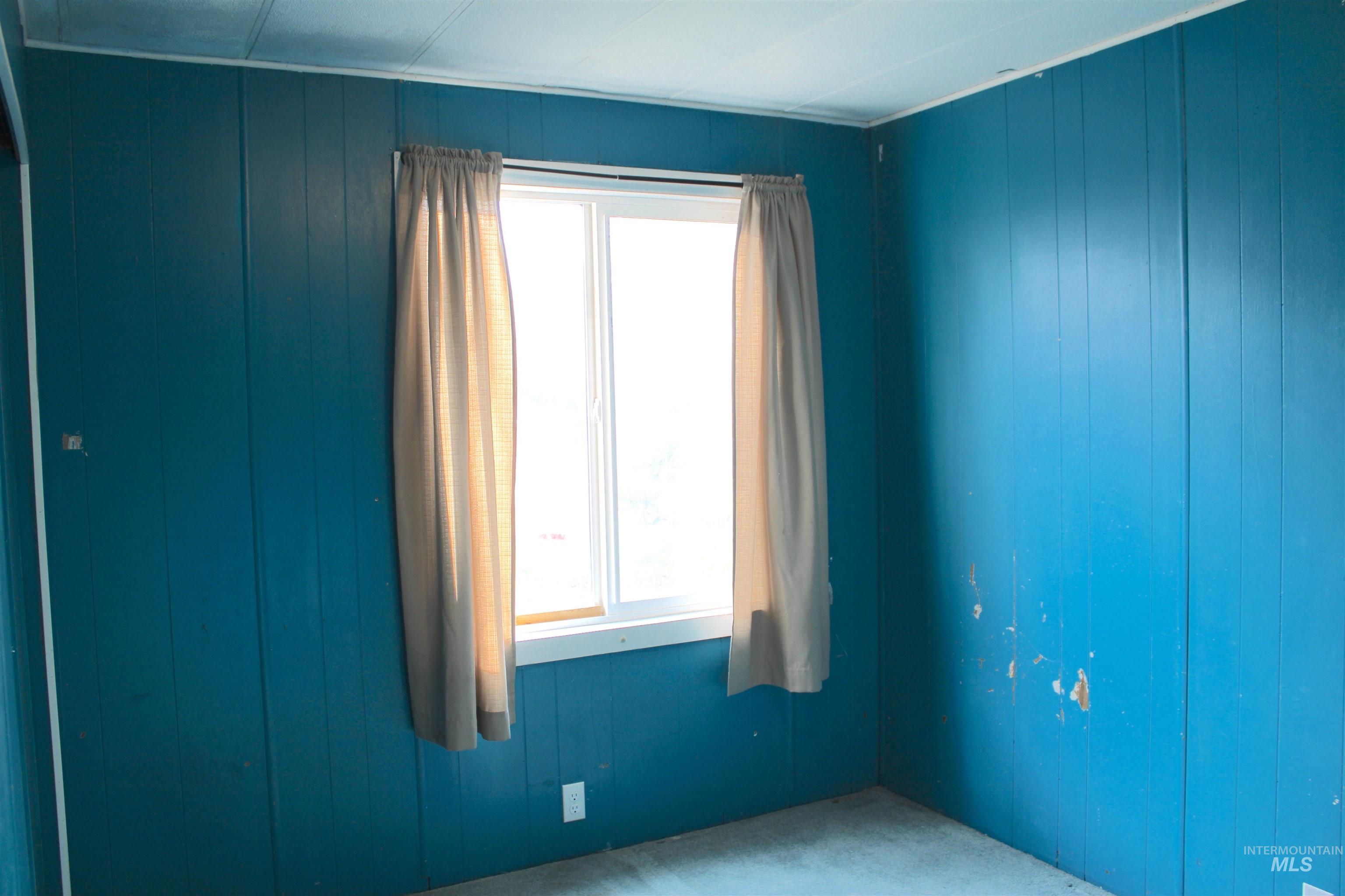 15881 Purple Sage Road, Unit 3 Caldwell, ID 83607 - Photo 12 of 29 Spare room featuring wooden walls