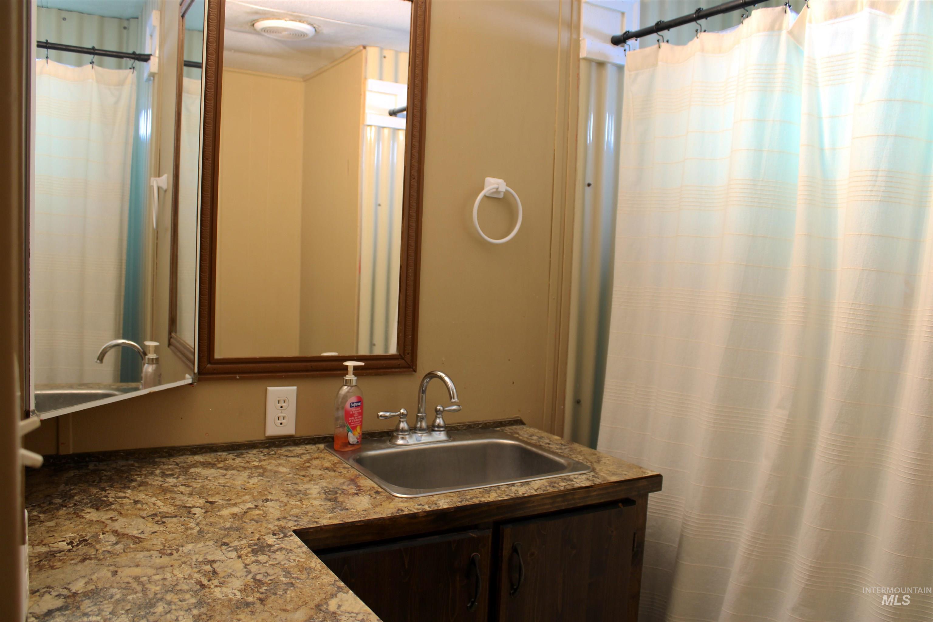 15881 Purple Sage Road, Unit 3 Caldwell, ID 83607 - Photo 14 of 29 Full bath with vanity and a shower with shower curtain