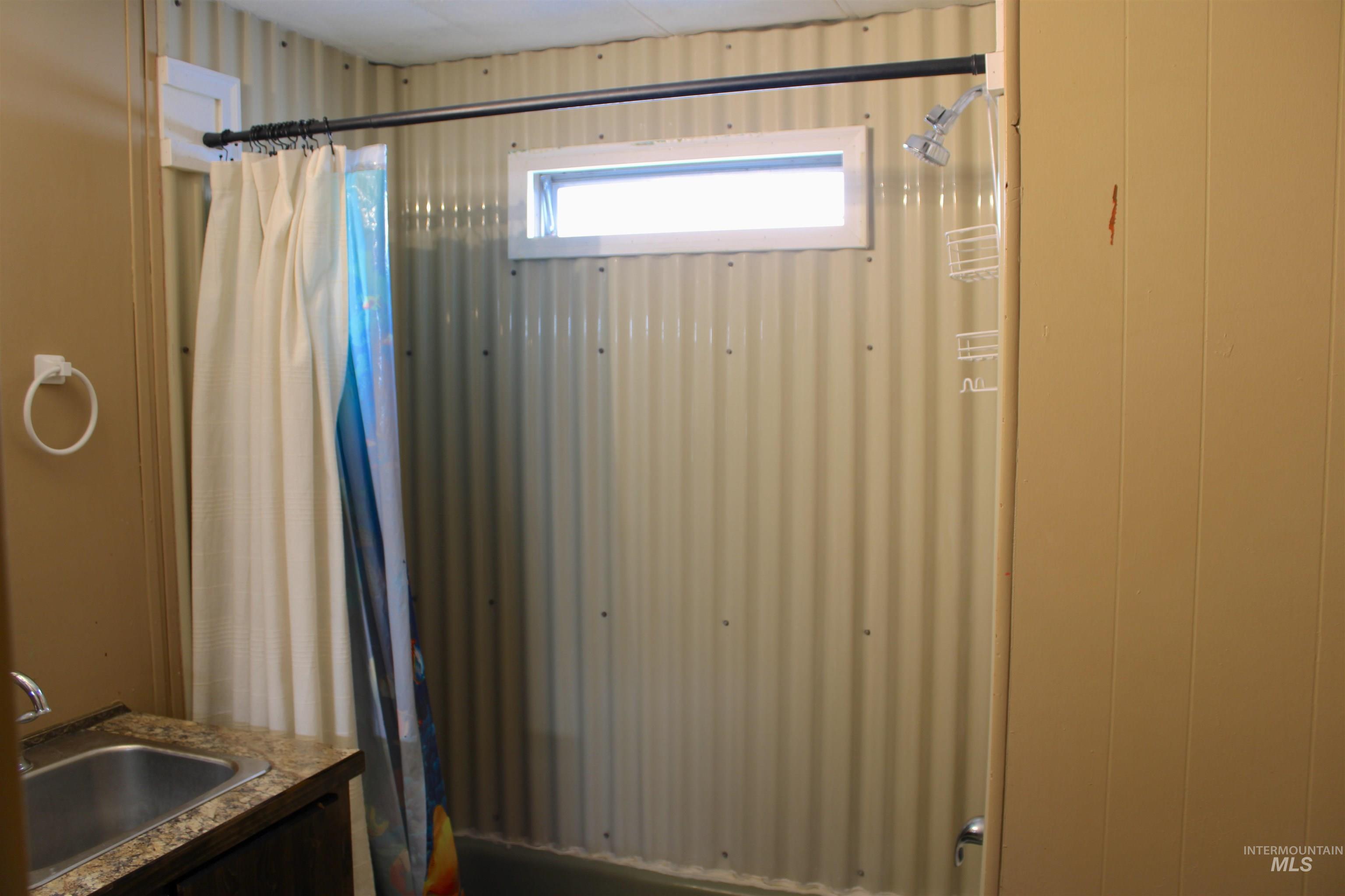 15881 Purple Sage Road, Unit 3 Caldwell, ID 83607 - Photo 15 of 29 Bathroom with vanity and shower / tub combo with curtain