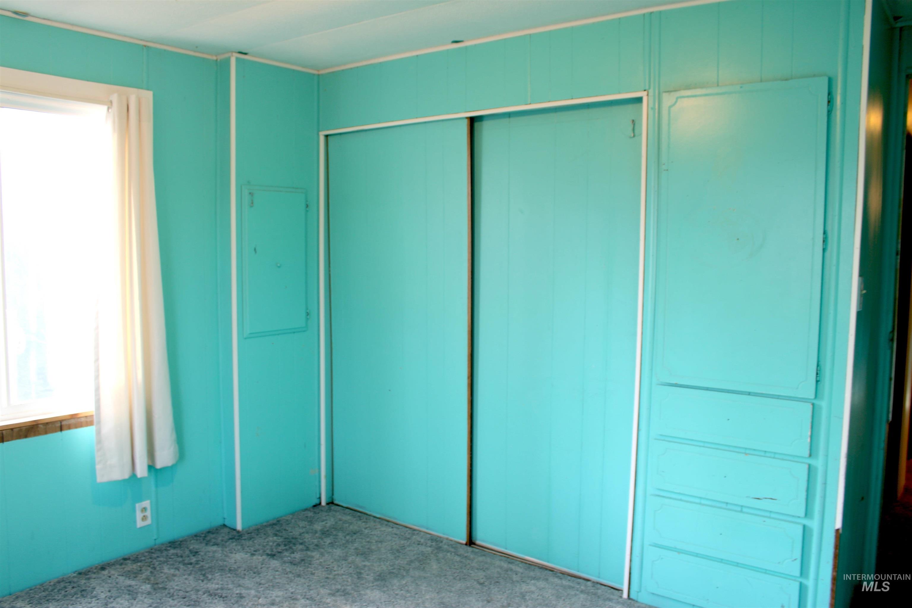 15881 Purple Sage Road, Unit 3 Caldwell, ID 83607 - Photo 20 of 29 Unfurnished bedroom featuring carpet, multiple windows, and a closet