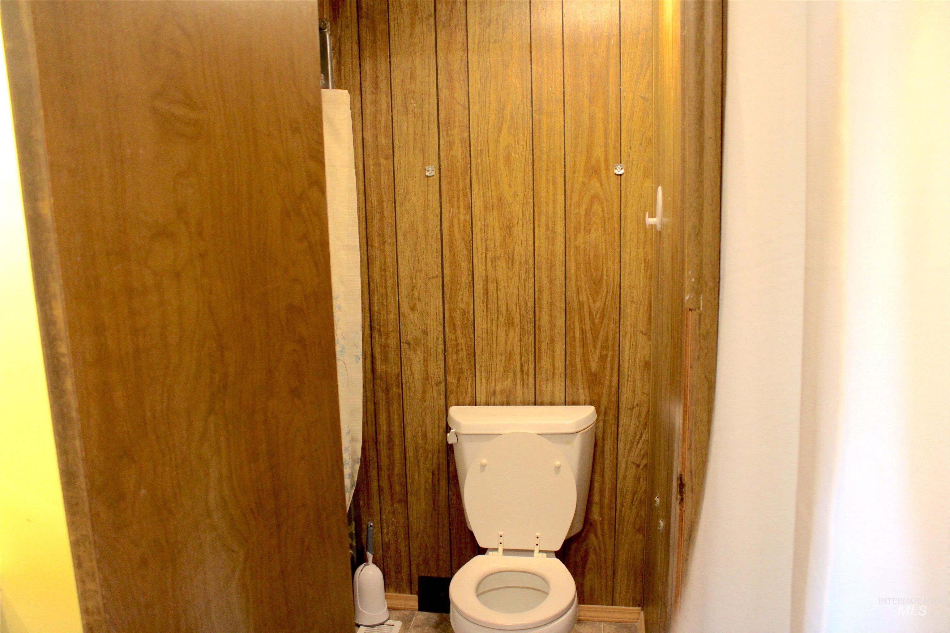 15881 Purple Sage Road, Unit 3 Caldwell, ID 83607 - Photo 24 of 29 Bathroom with toilet and wooden walls