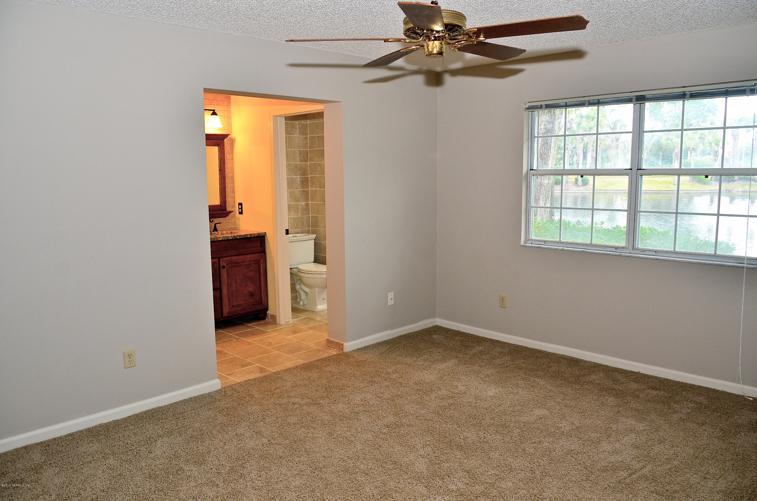 405 Tournament Road Ponte Vedra, FL 32082 - Photo 17 of 31 an empty room with windows and fan