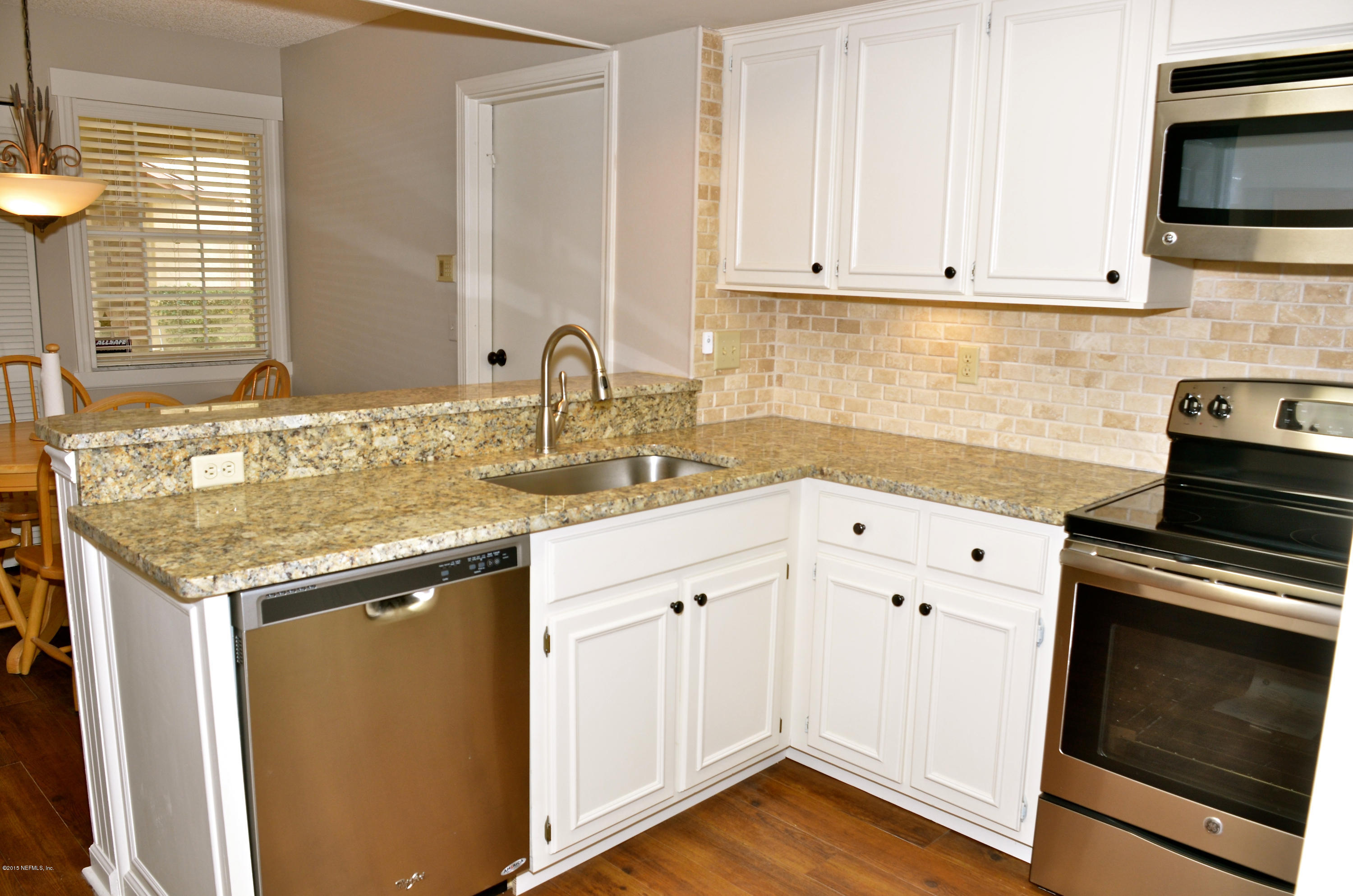405 Tournament Road Ponte Vedra, FL 32082 - Photo 9 of 31 a kitchen with granite countertop white cabinets and a stove