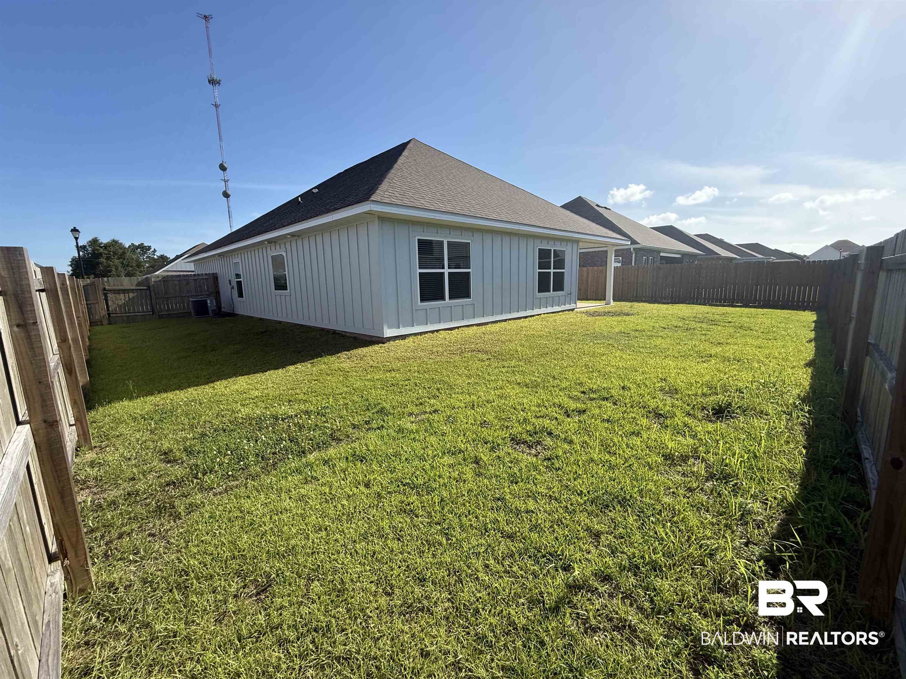 23247 Lieutenant Avenue Foley, AL 36535 - Photo 40 of 47 Expansive grassed backyard framed by wood fencing