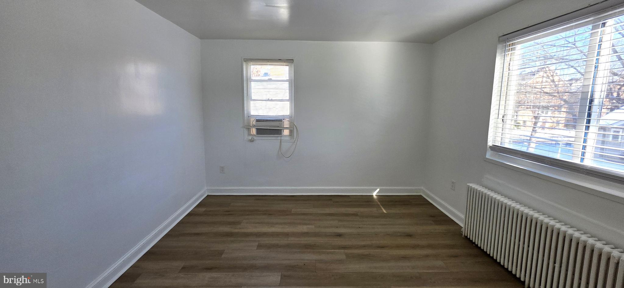 3207 11th Place Southeast, Unit 4 Washington, DC 20032 - Photo 5 of 16 a view of a hallway with wooden floor and a window