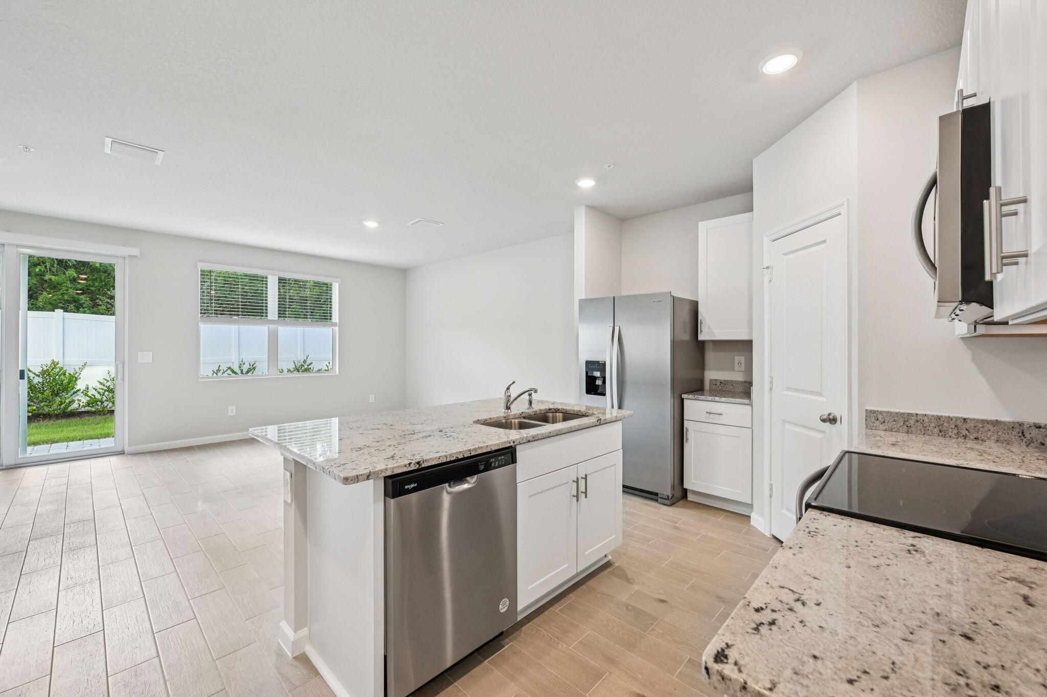 458 Salisbury Circle Fort Pierce, FL 34982 - Photo 11 of 32 a kitchen with stainless steel appliances granite countertop a sink a stove a refrigerator a washer dryer and a dining table
