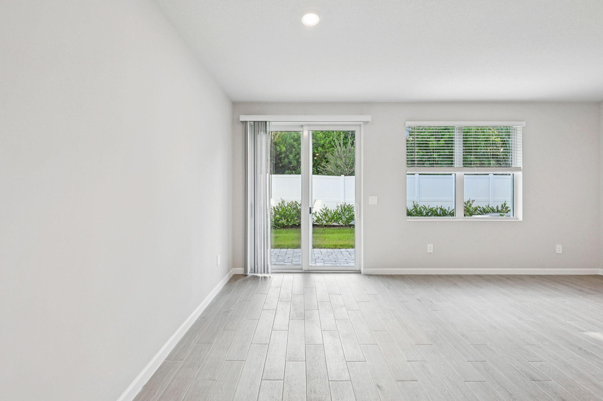458 Salisbury Circle Fort Pierce, FL 34982 - Photo 13 of 32 an empty room with wooden floor and windows