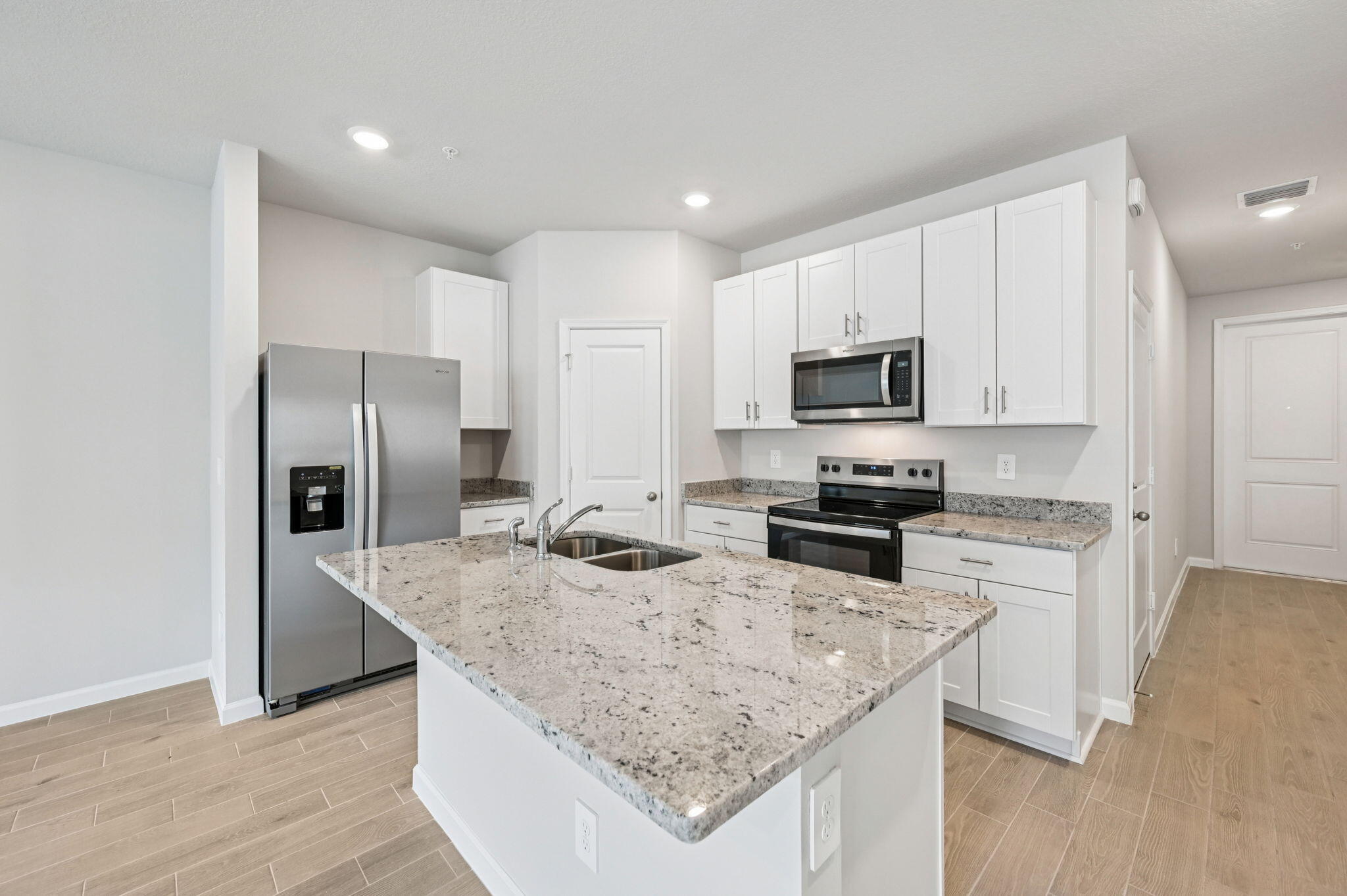 458 Salisbury Circle Fort Pierce, FL 34982 - Photo 6 of 32 a kitchen with stainless steel appliances granite countertop a sink stove microwave and refrigerator